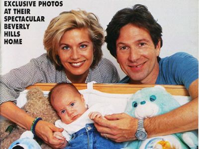 Both Glynis Barber and Michael Brandon are holding the hands of Alexander Mac Brandon in the picture.